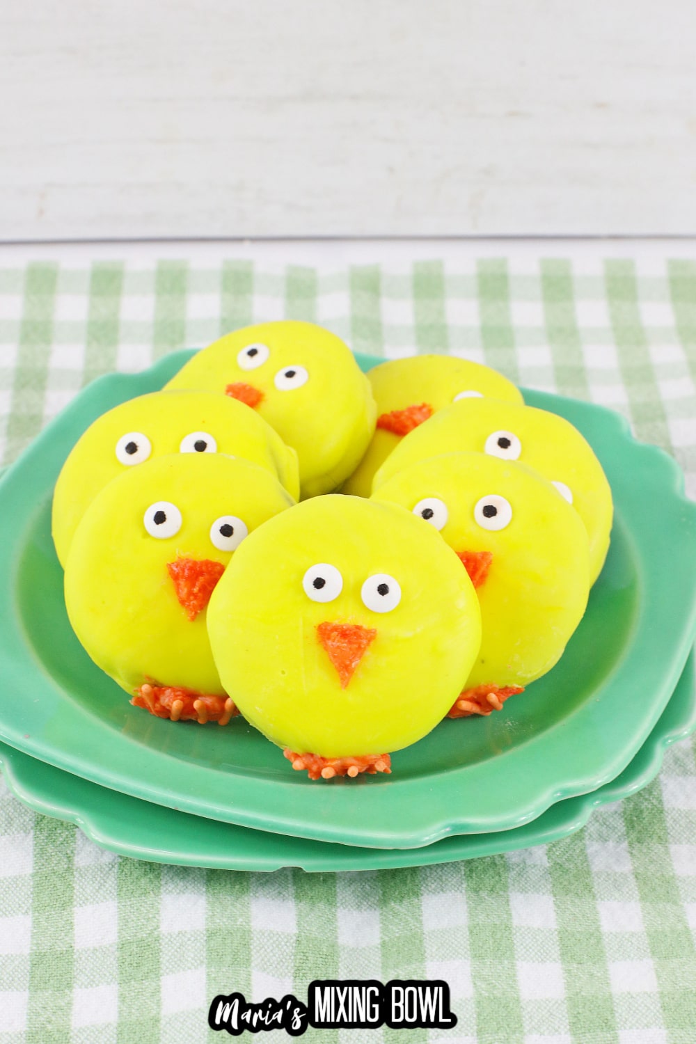 seven easter chick oreos on a green and white checkered napkin