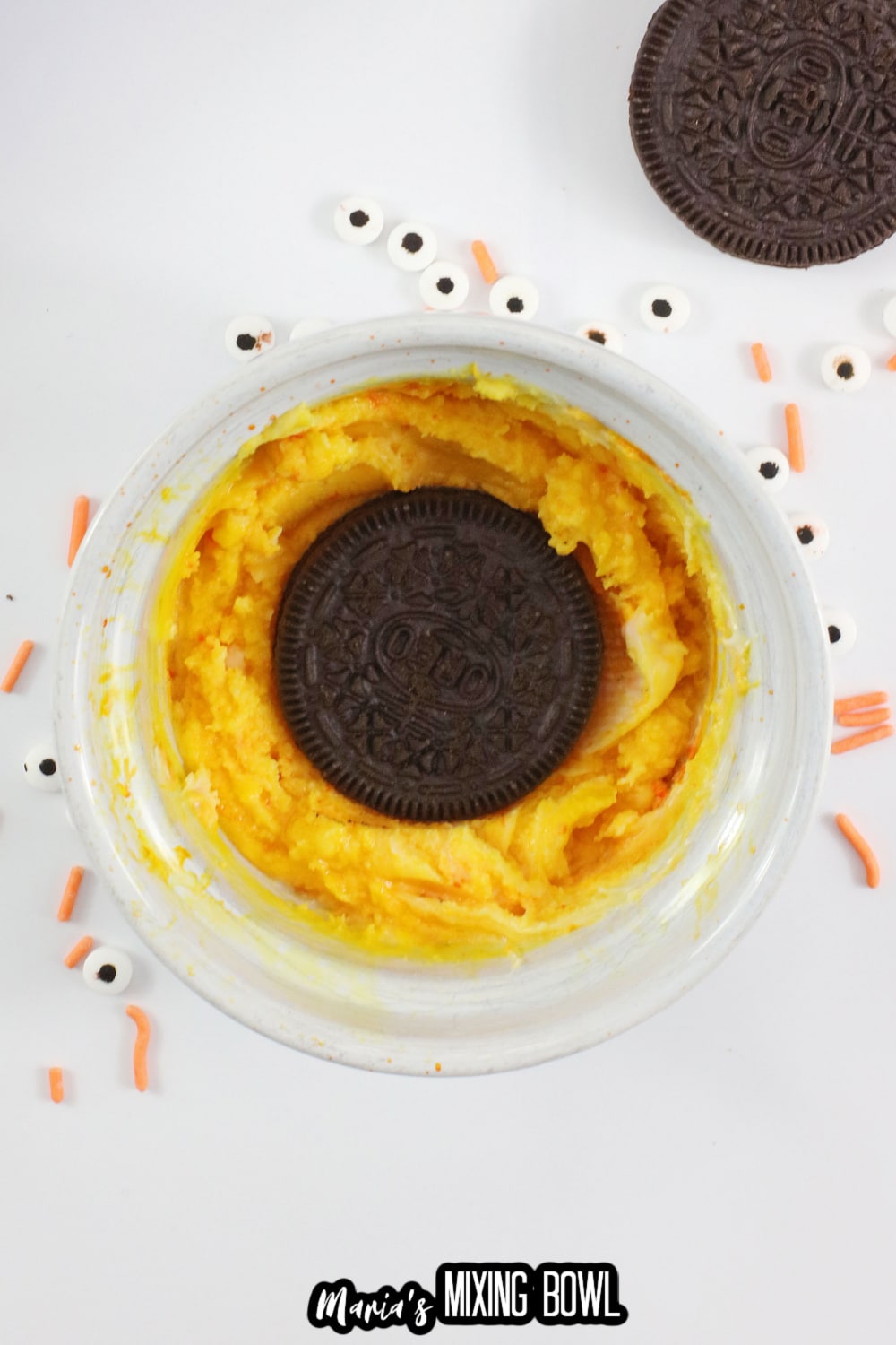 cookie being dipped into yellow chocolate