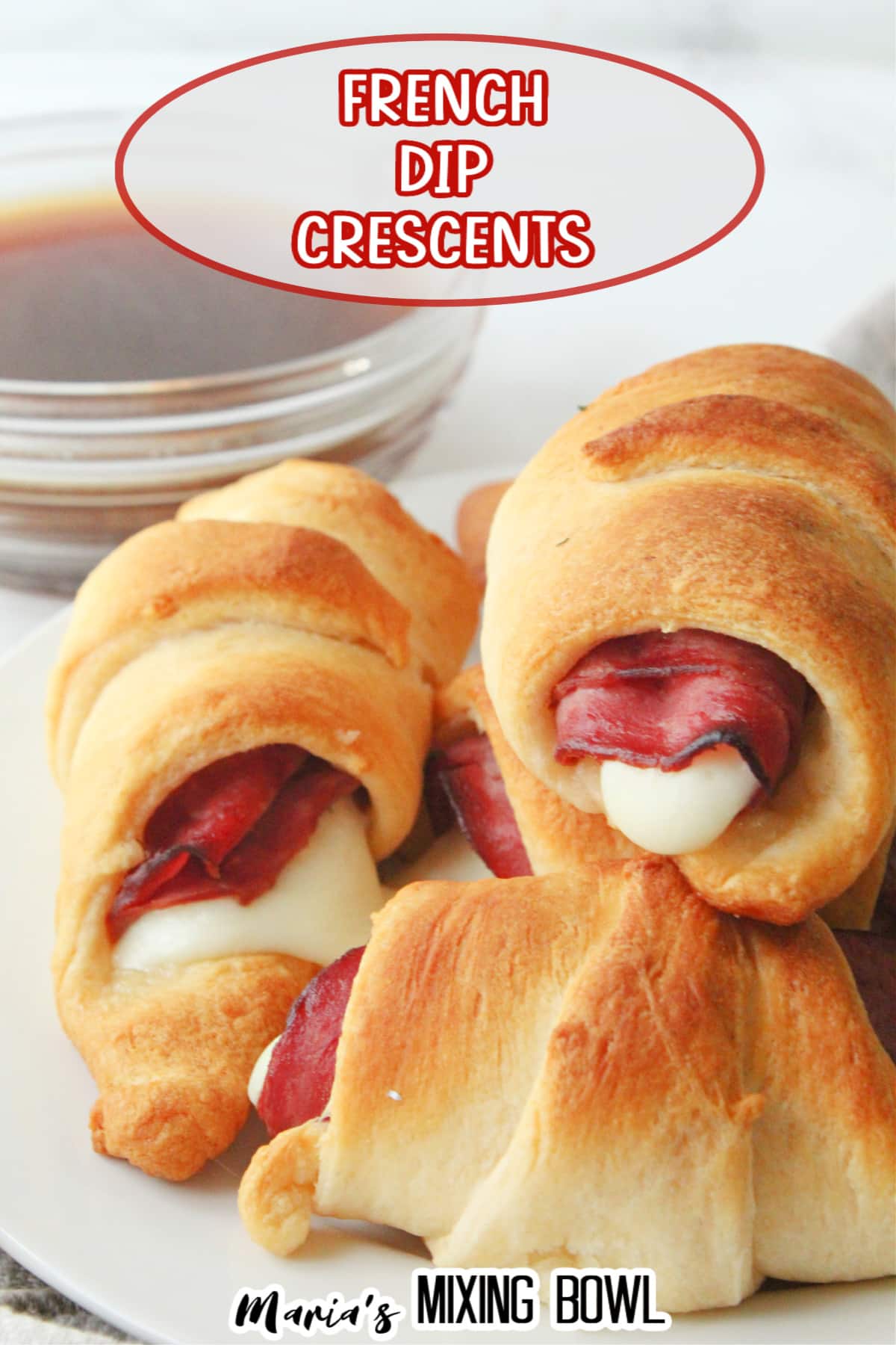 stack of french dip crescents on a white plate