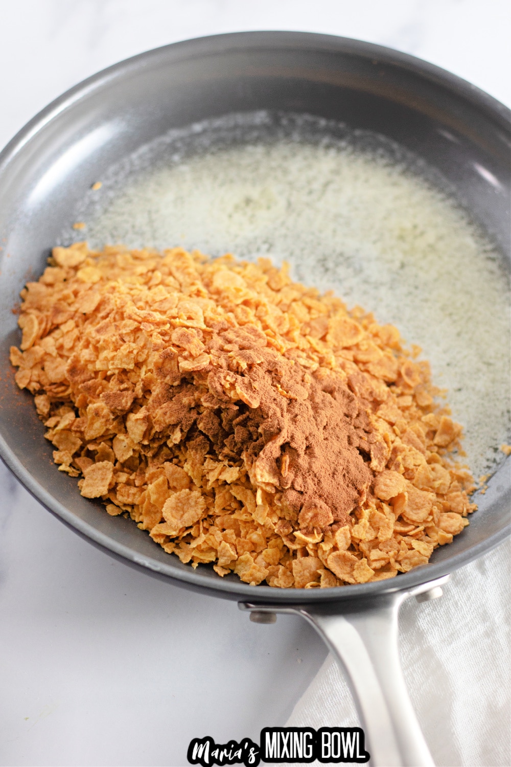 cornflakes, cinnamon and melted butter in a skillet