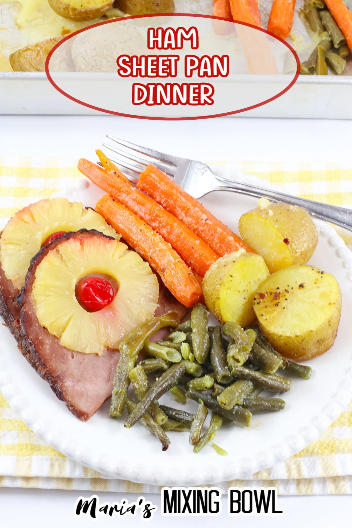 close up of ham, carrots, green beans, and potatoes on a white plate