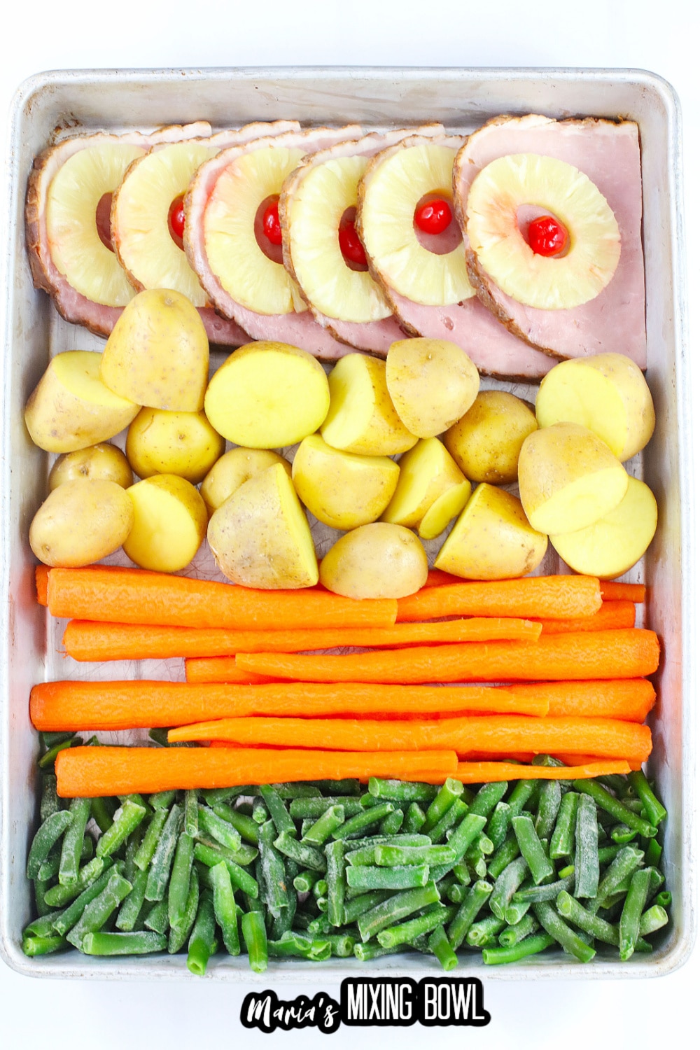 ham, carrots, green beans, and potatoes on a baking dish