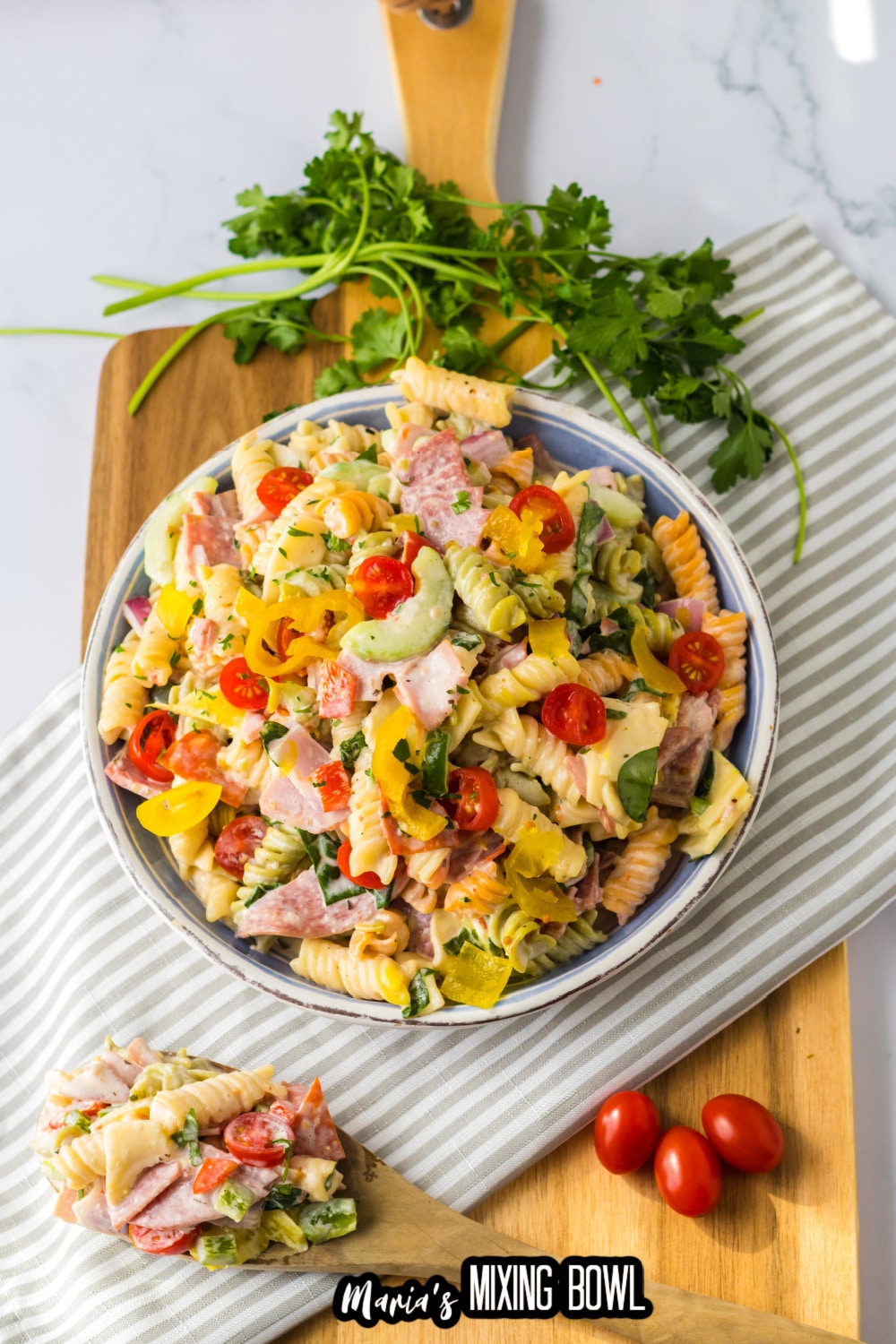 italian sub pasta salad in a white and blue bowl