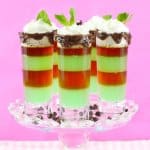 four mint shots on a clear glass cake stand