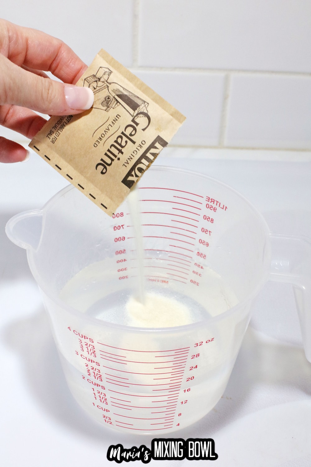 gelatin powder being mixed into a measuring cup with water