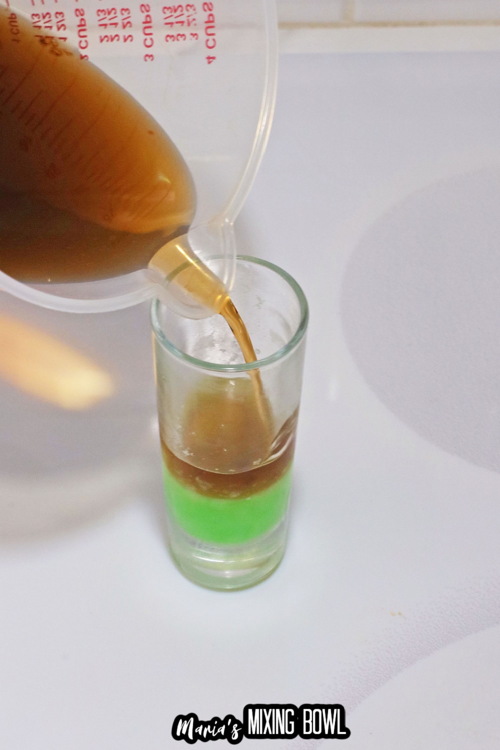 shot glass being filled with gelatin mixture