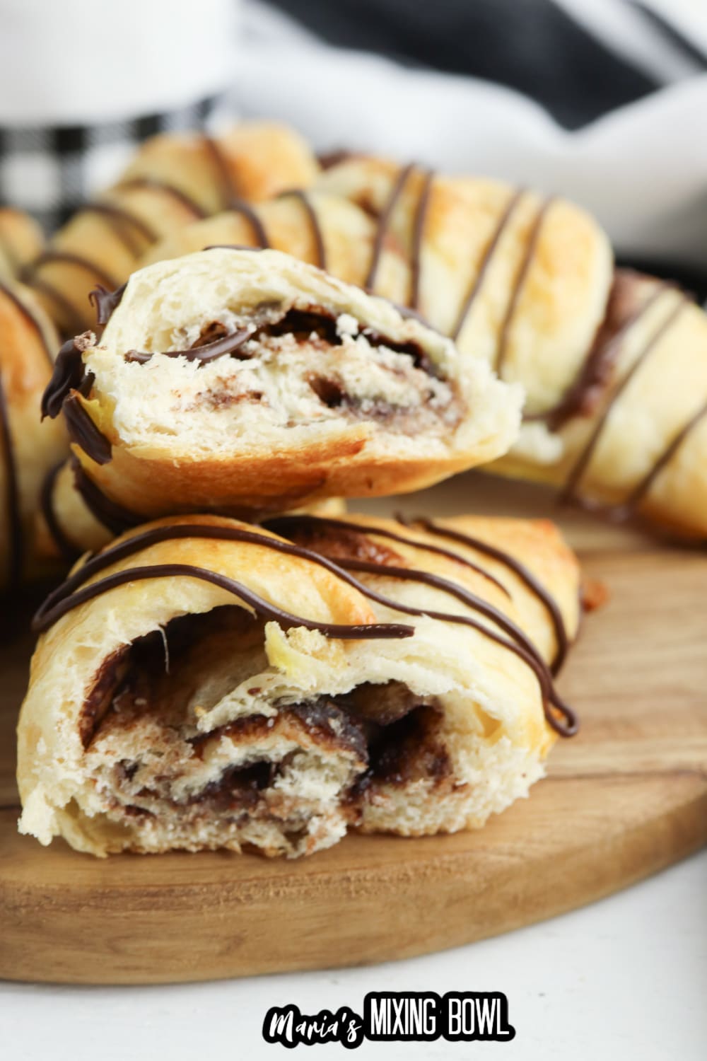 nutella crescent rolls broken in half with chocolate drizzled in half