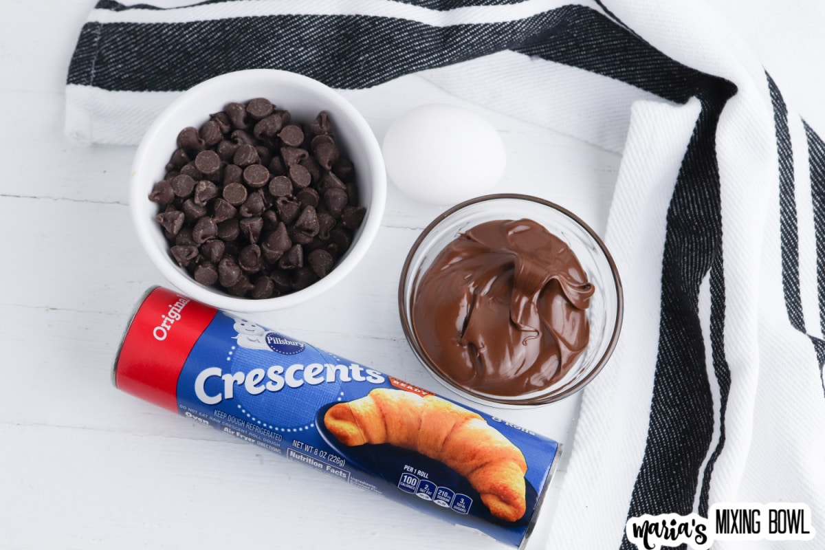 crescent rolls, chocolate chips, and small bowl on nutella