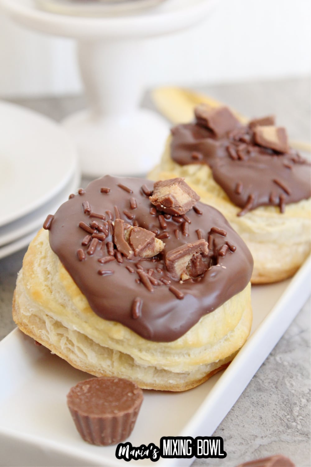 two reeses stuffed donuts on a white plate
