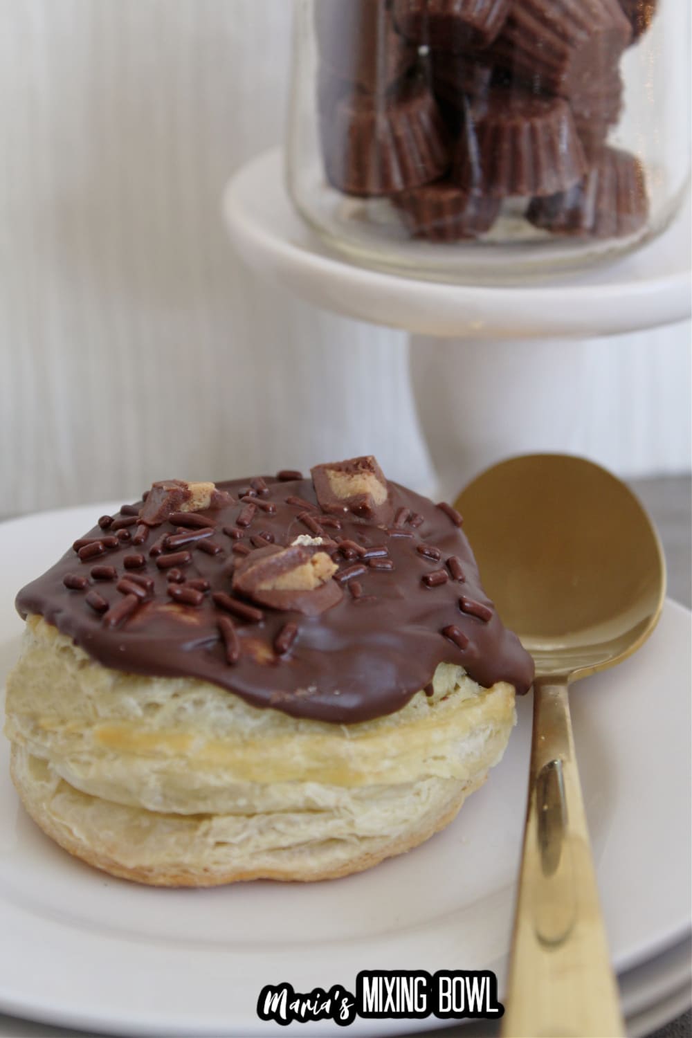 reeses stuffed donuts on a white plate with a gold spoon