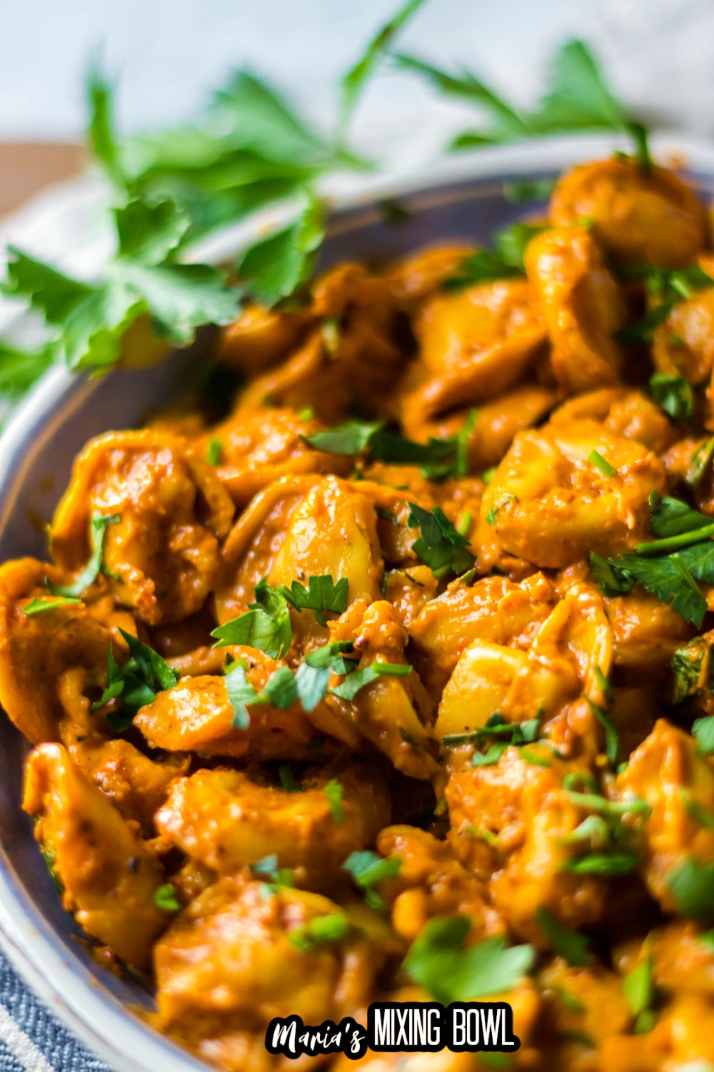 roasted red pepper tortellini in a blue and white bowl