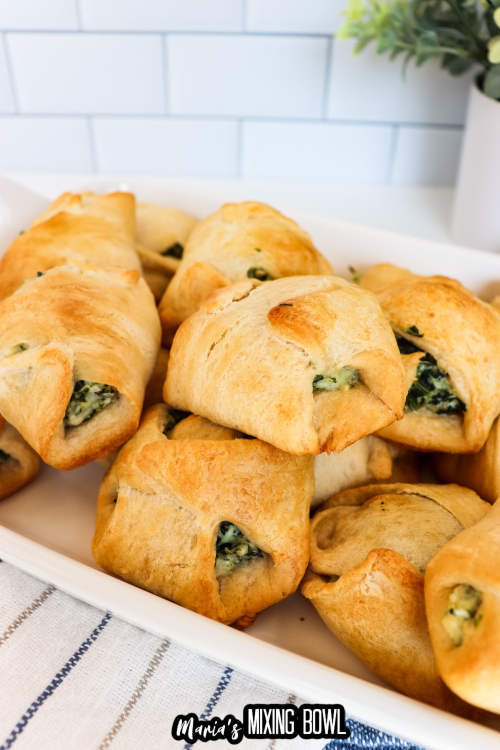 spinach cheese crescent rolls on a white platter
