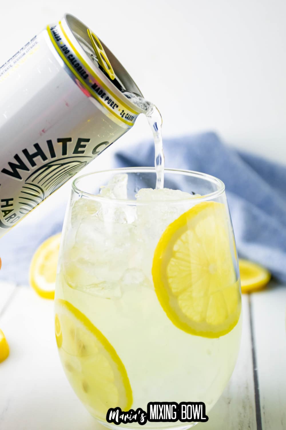 white claw being poured into a cocktail glass