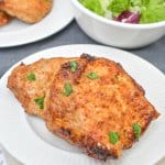 two air fryer pork chops on a white plate