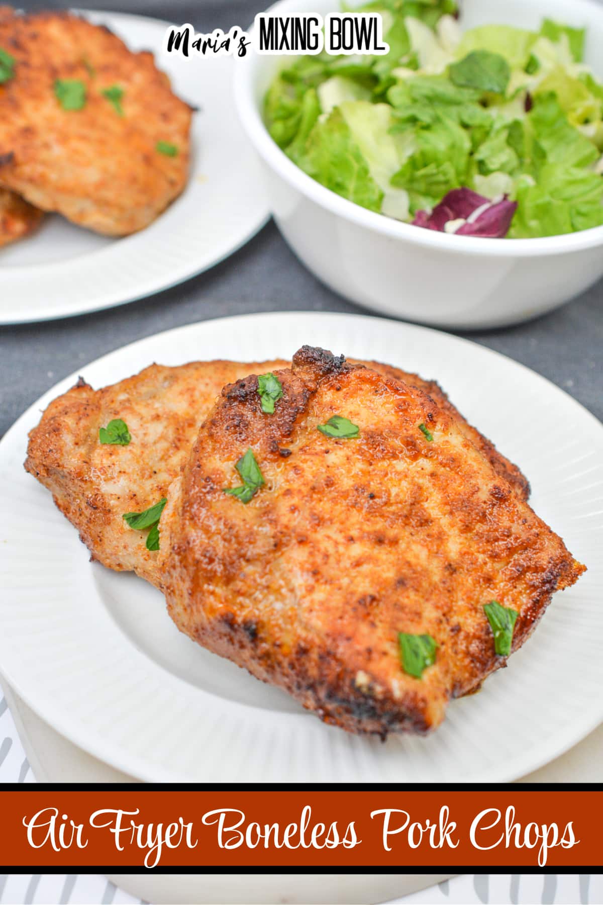 two air fryer pork chops on a white plate