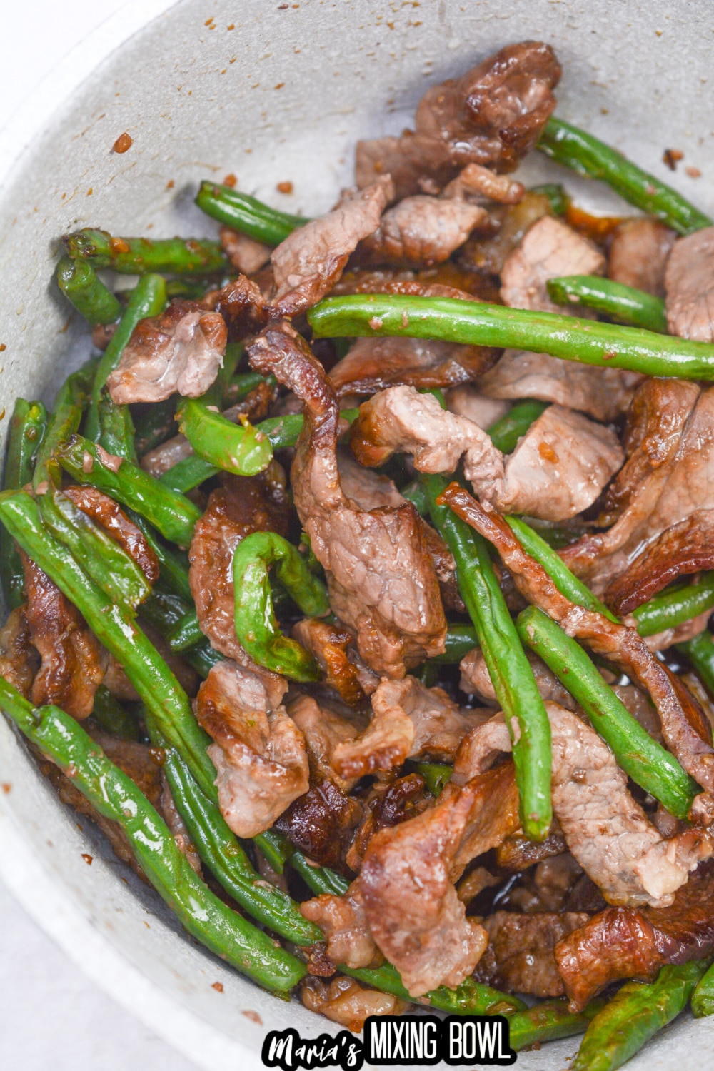 green beans and cooked beef in a white bowl