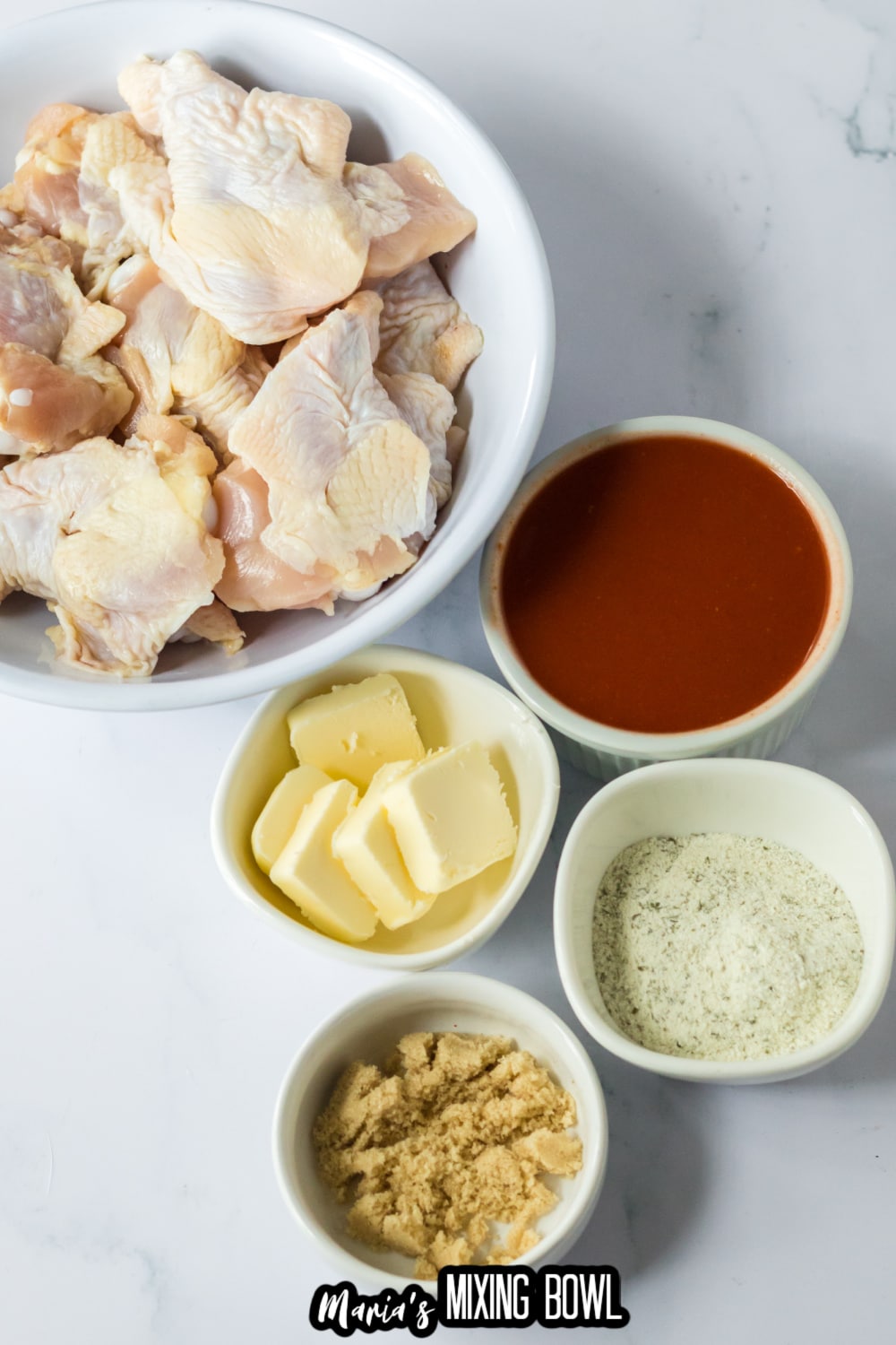 wings, buffalo sauce, butter, ranch seasoning and brown sugar on a white backdrop
