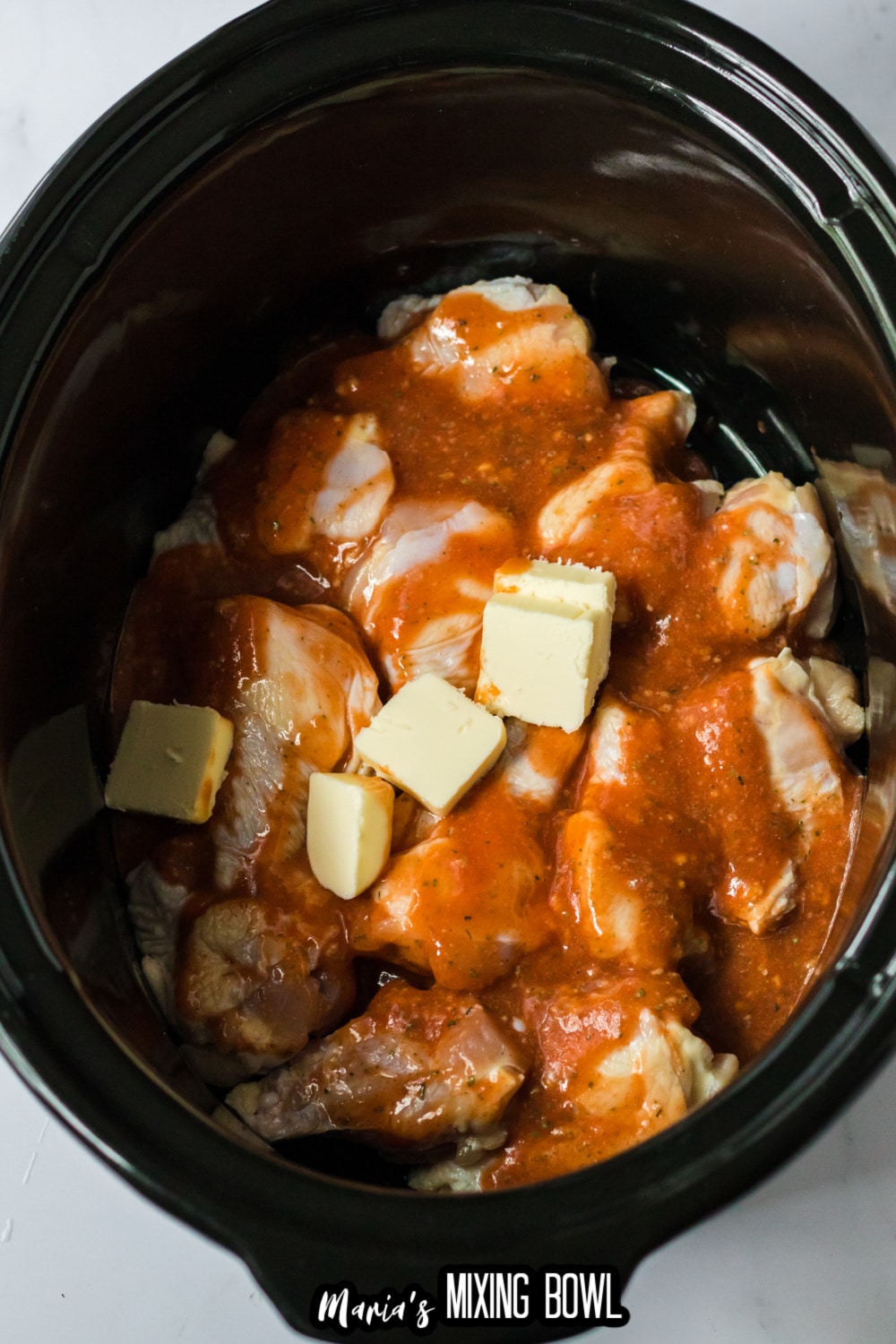 wings, butter, and sauce in a slow cooker
