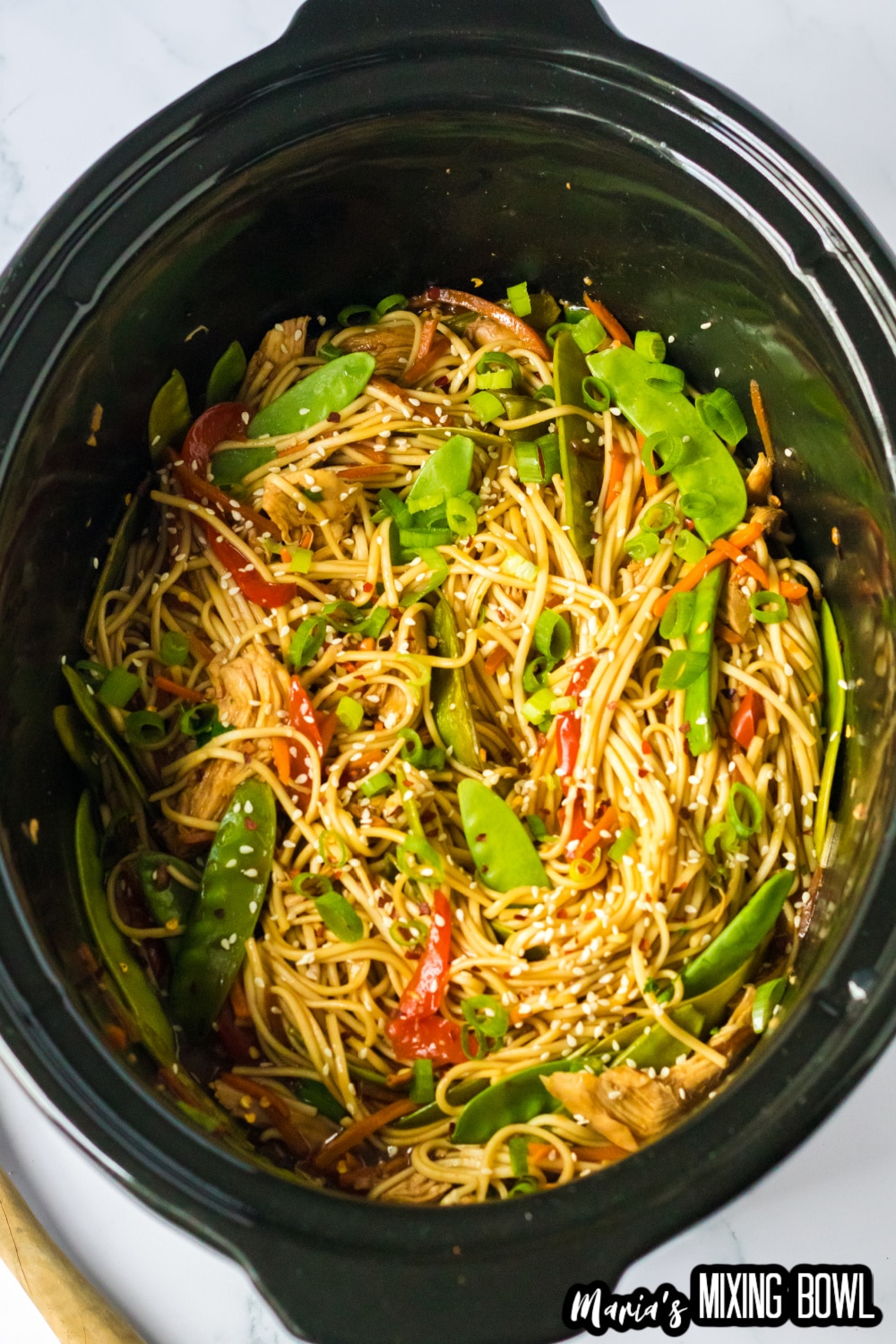 cooked chicken lo mein in a slow cooker