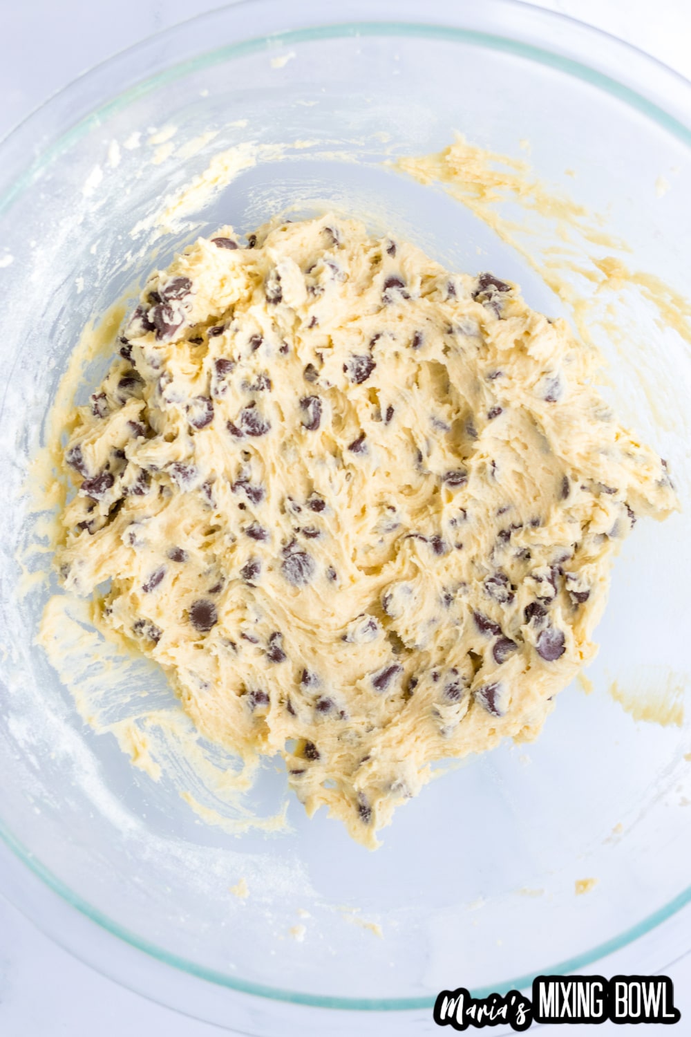 cookie dough in a glass mixing bowl