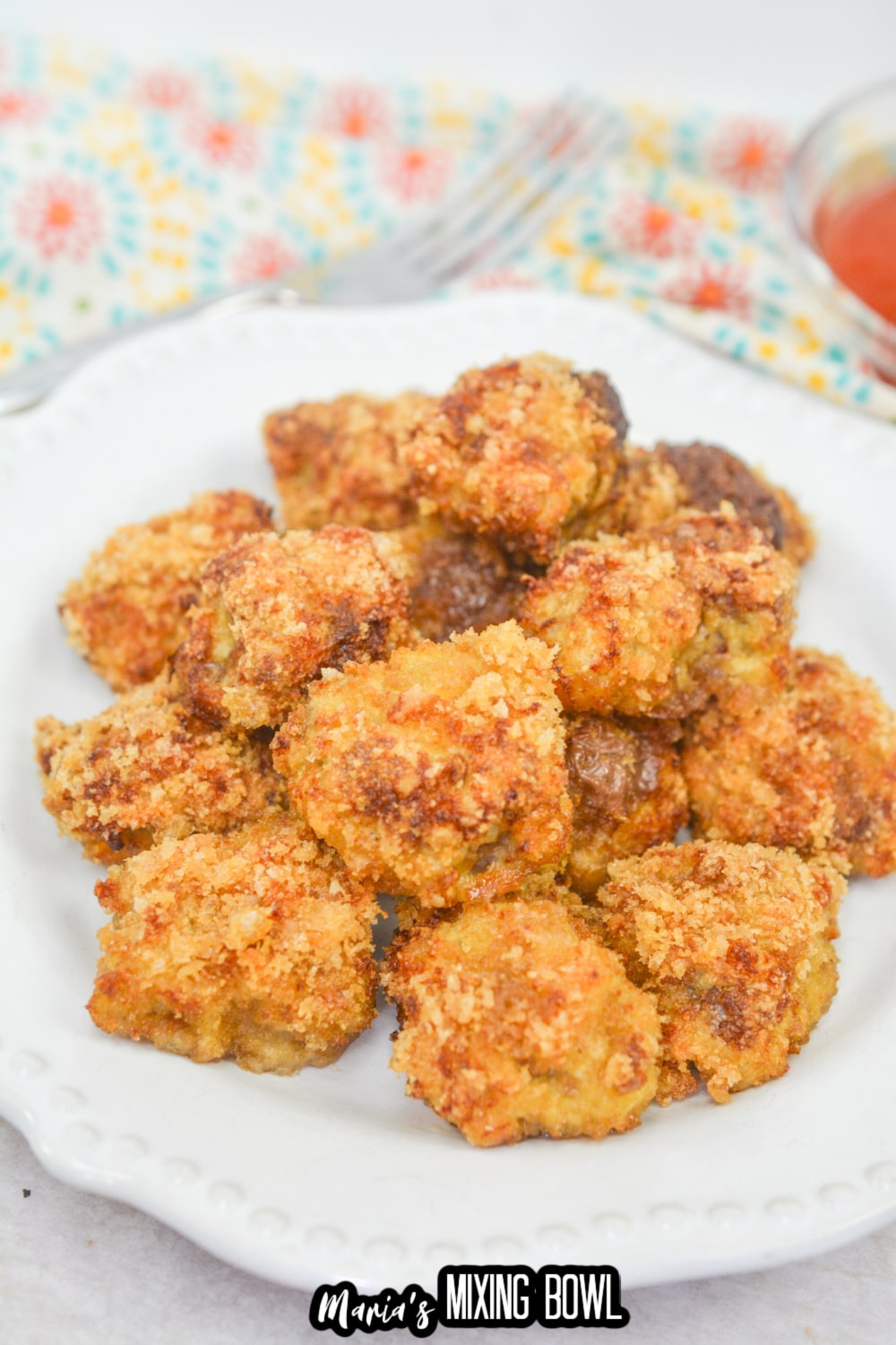 stack of country fried steak bites on a white plate