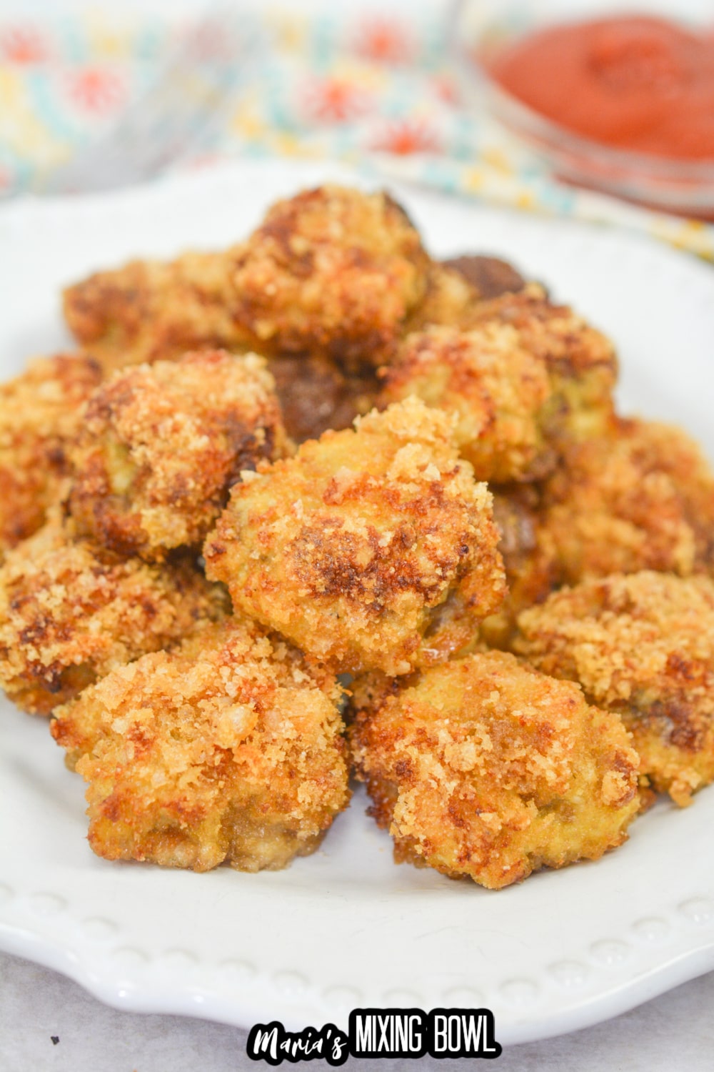stack of country fried steak bites on a white plate