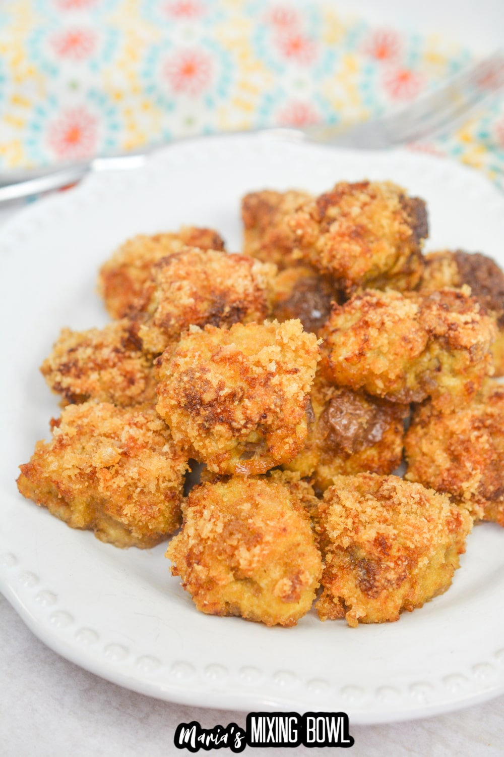 stack of country fried steak bites on a white plate