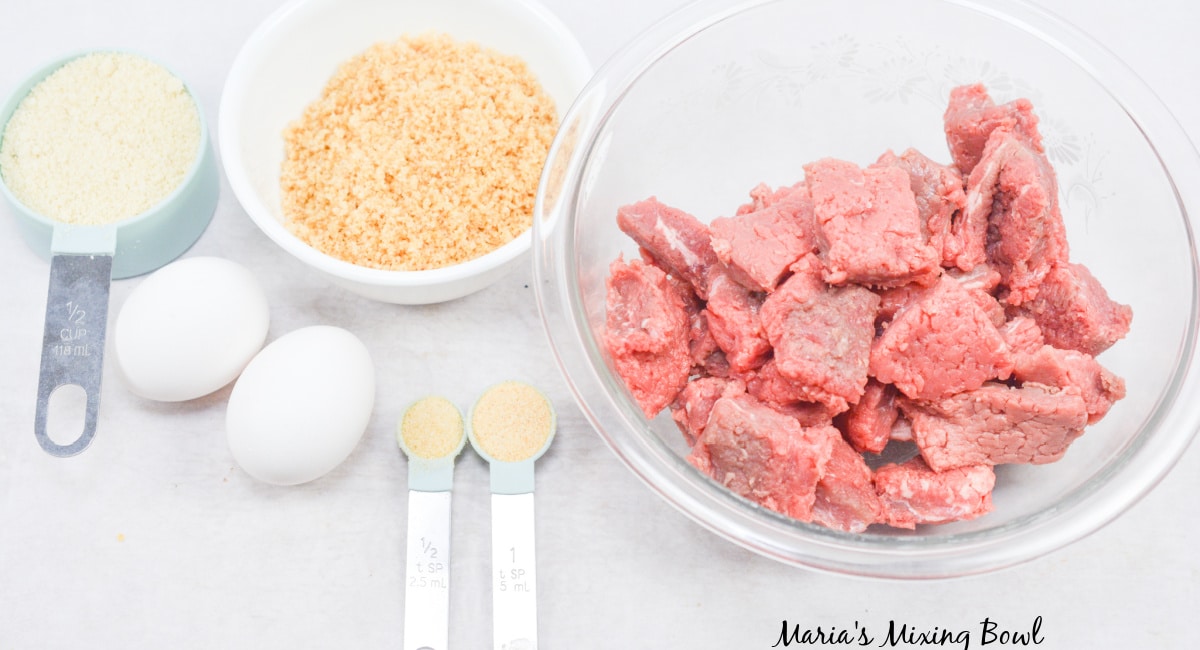 bowls of beef, bread crumbs, seasonings, flour, and eggs