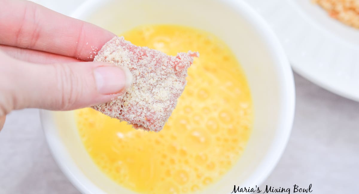 steak bite being dipped in egg wash
