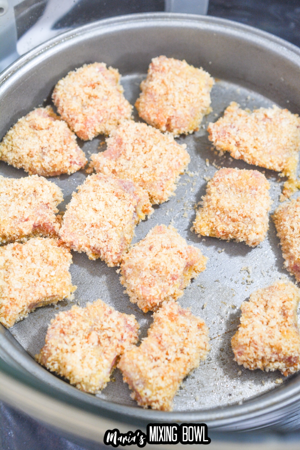 breaded steak bites in a cake pan