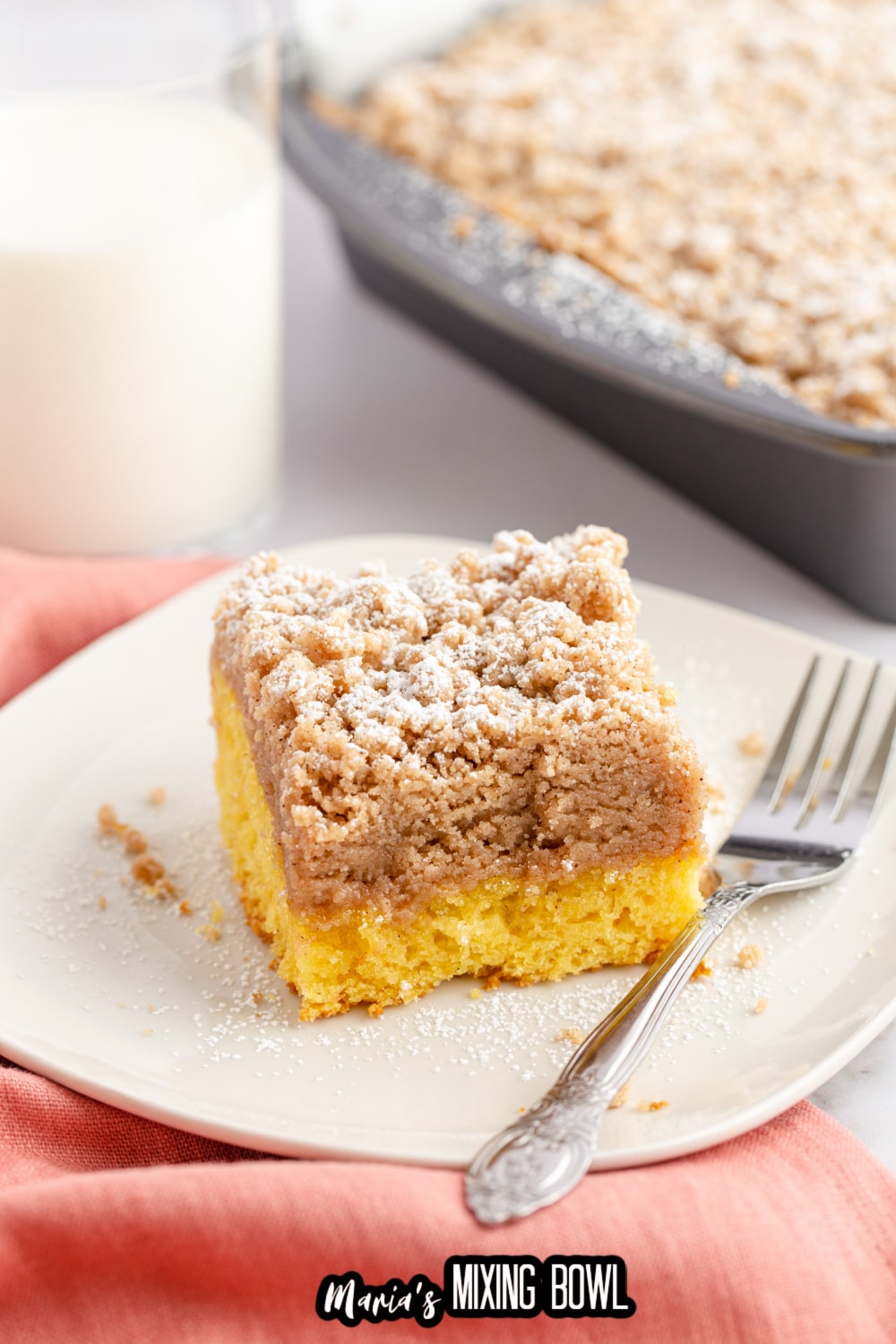 slice of double crumb cake on a white plate with a fork