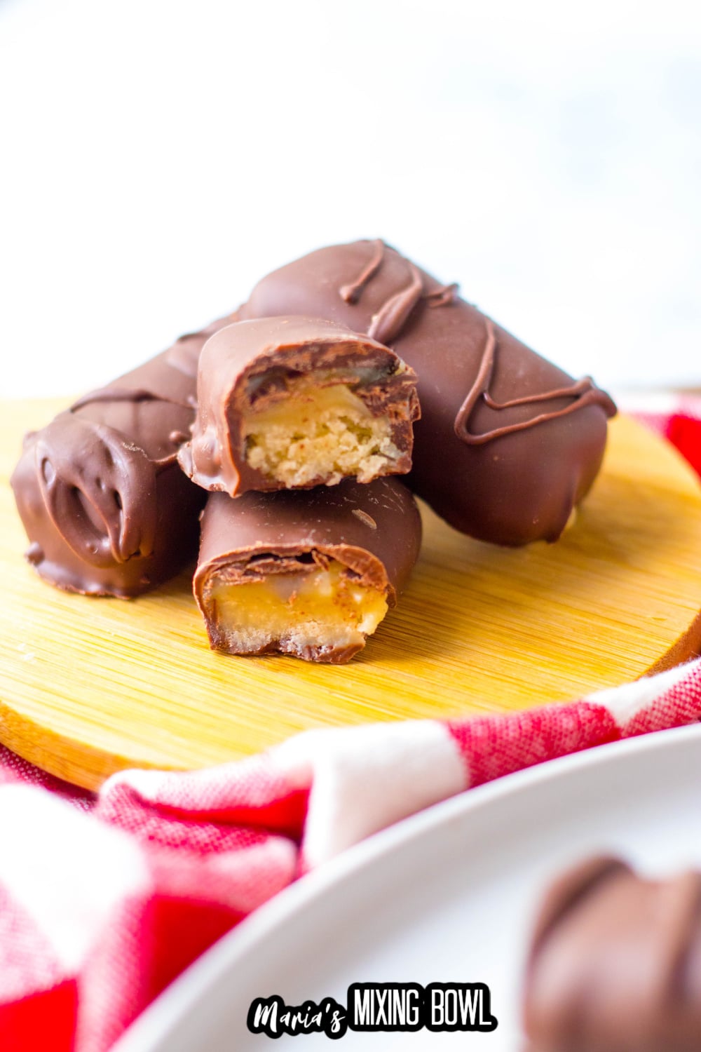 homemade twix bars stacked on a wooden cutting board