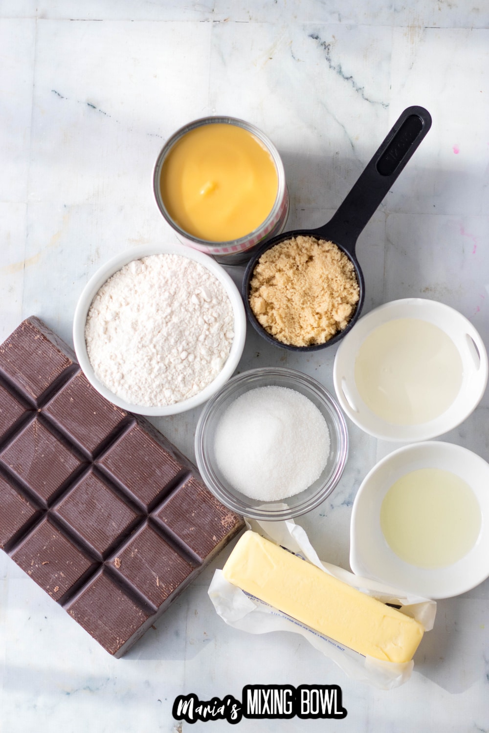 almond bark, butter, sugar, flour, condensed milk, on a marble slab