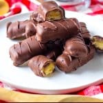 homemade twix bars stacked on a white plate