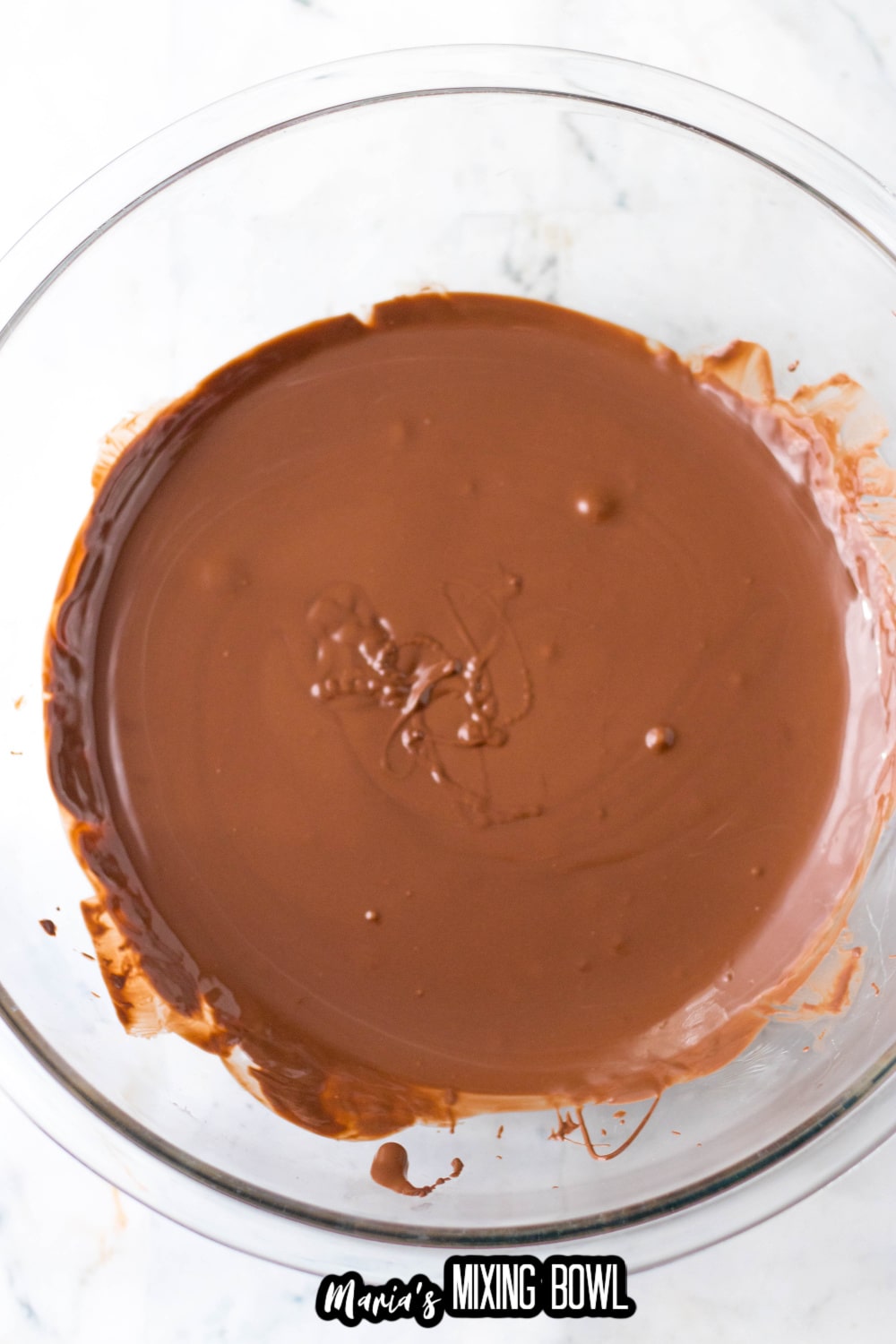 melted almond bark in a glass mixing bowl