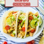 three honey lime chicken tacos on a white plate