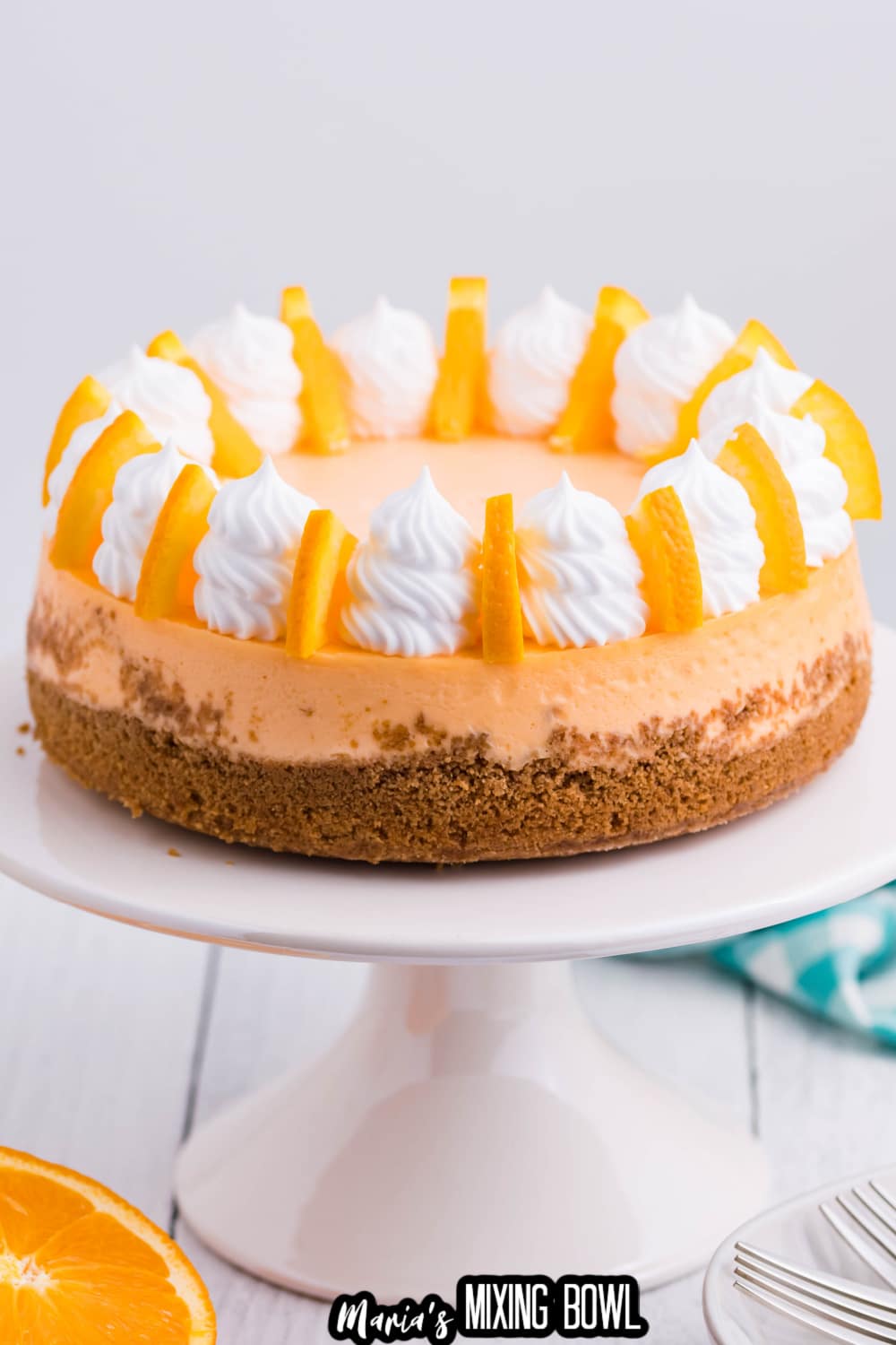 whole uncut cheesecake on a white cake stand