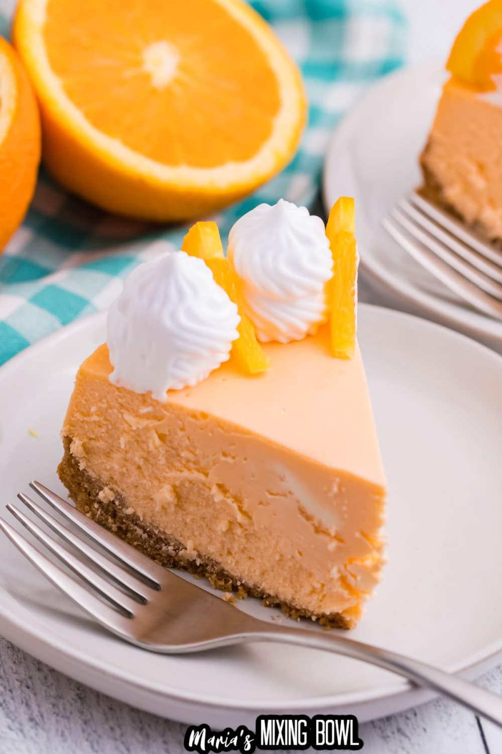 slice of cheesecake on a white plate with a fork