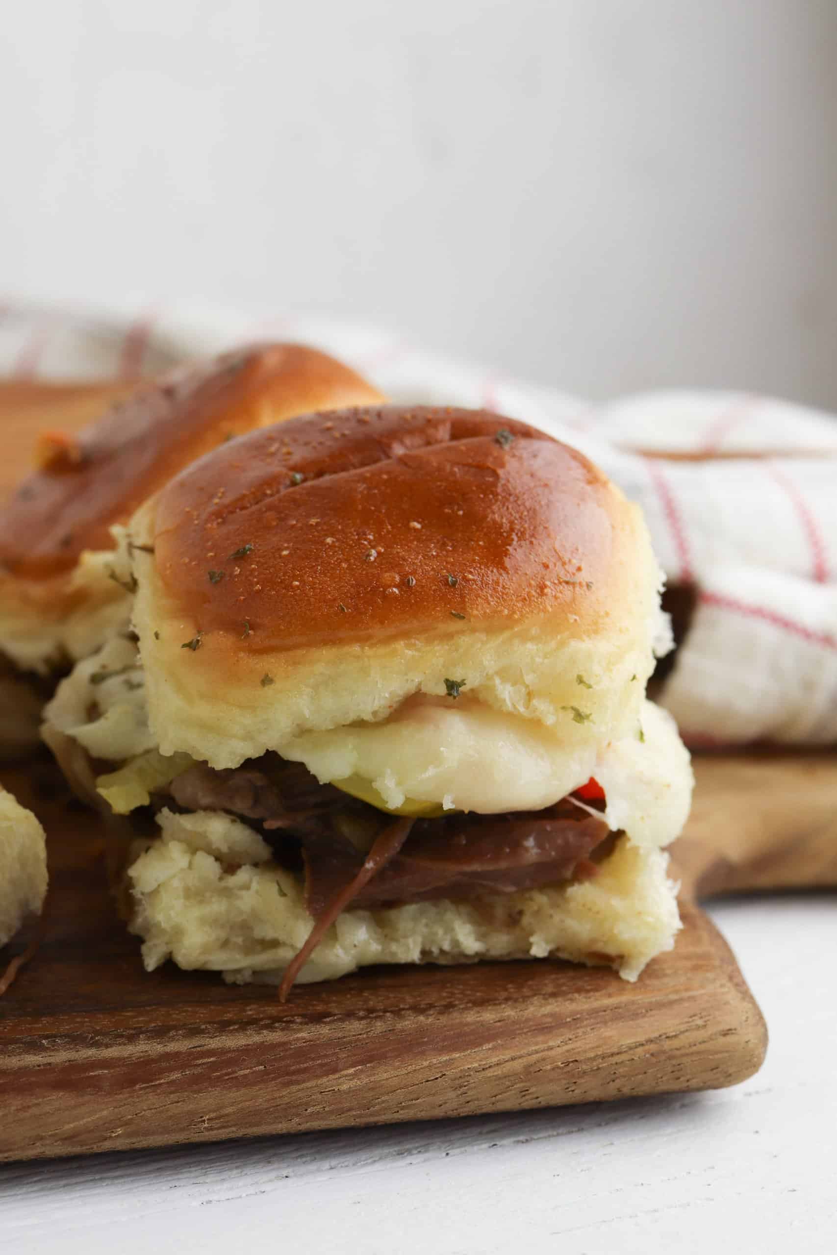 close up of an italian beef slider on a wooden cutting board