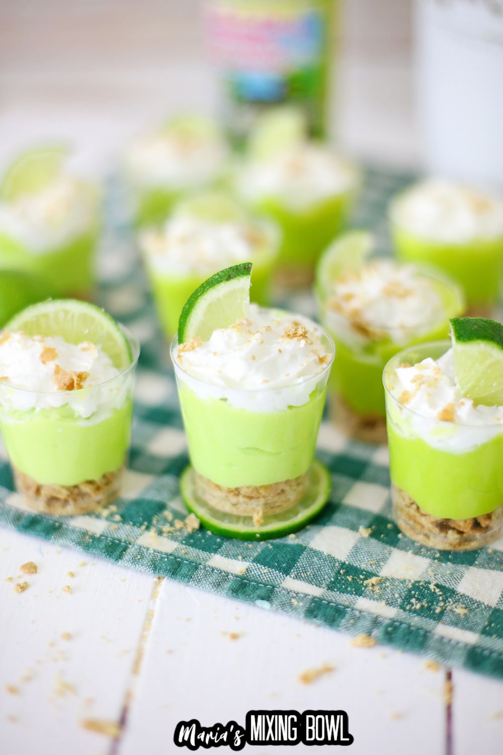 key lime pie shots on a green and white napkin