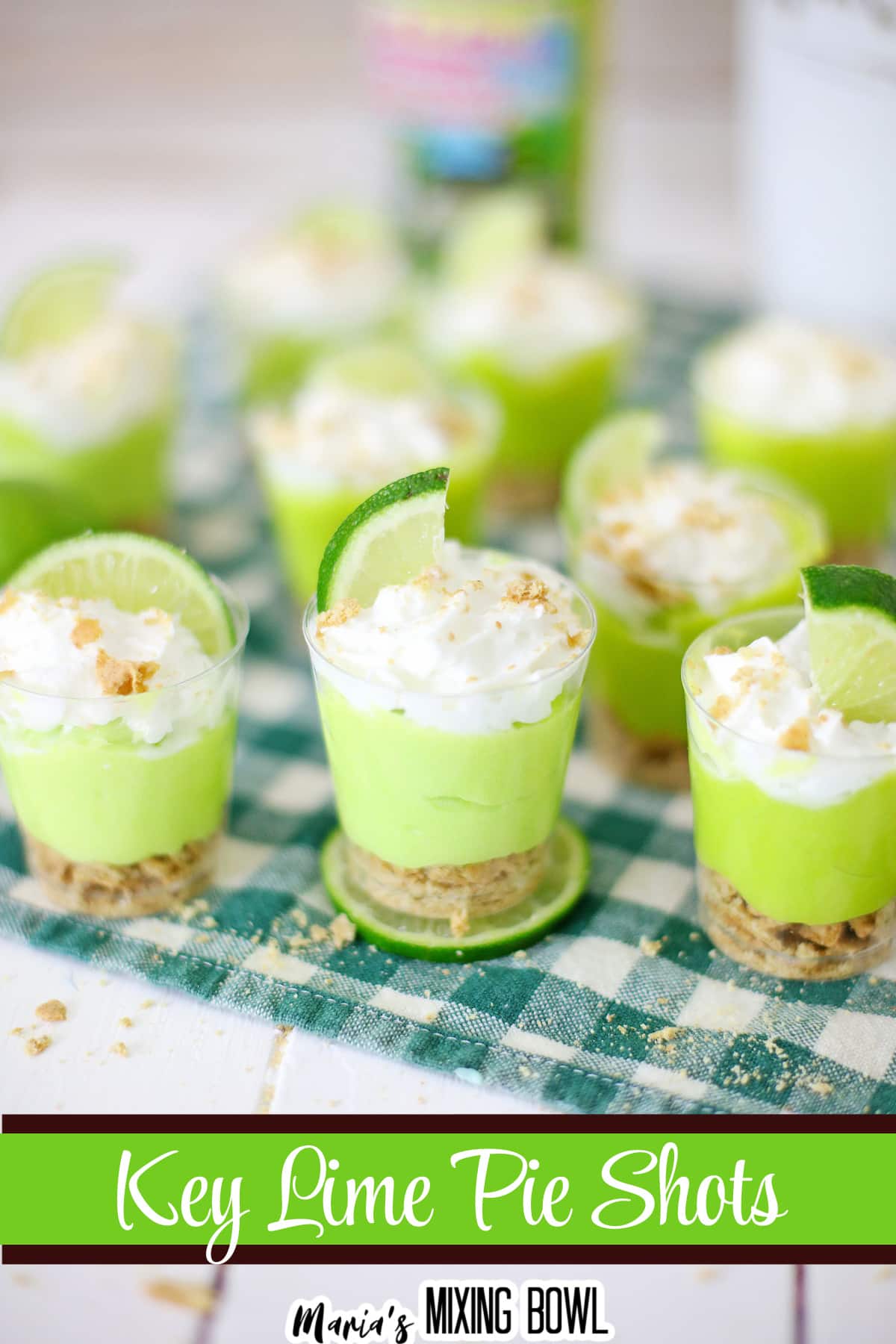 key lime pie shots on a green and white napkin