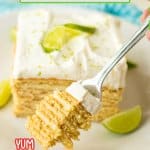 slice of key lime ice box cake on a white plate with lime wedges