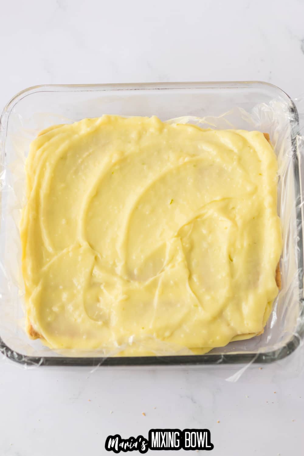 key lime custard being spread on graham crackers
