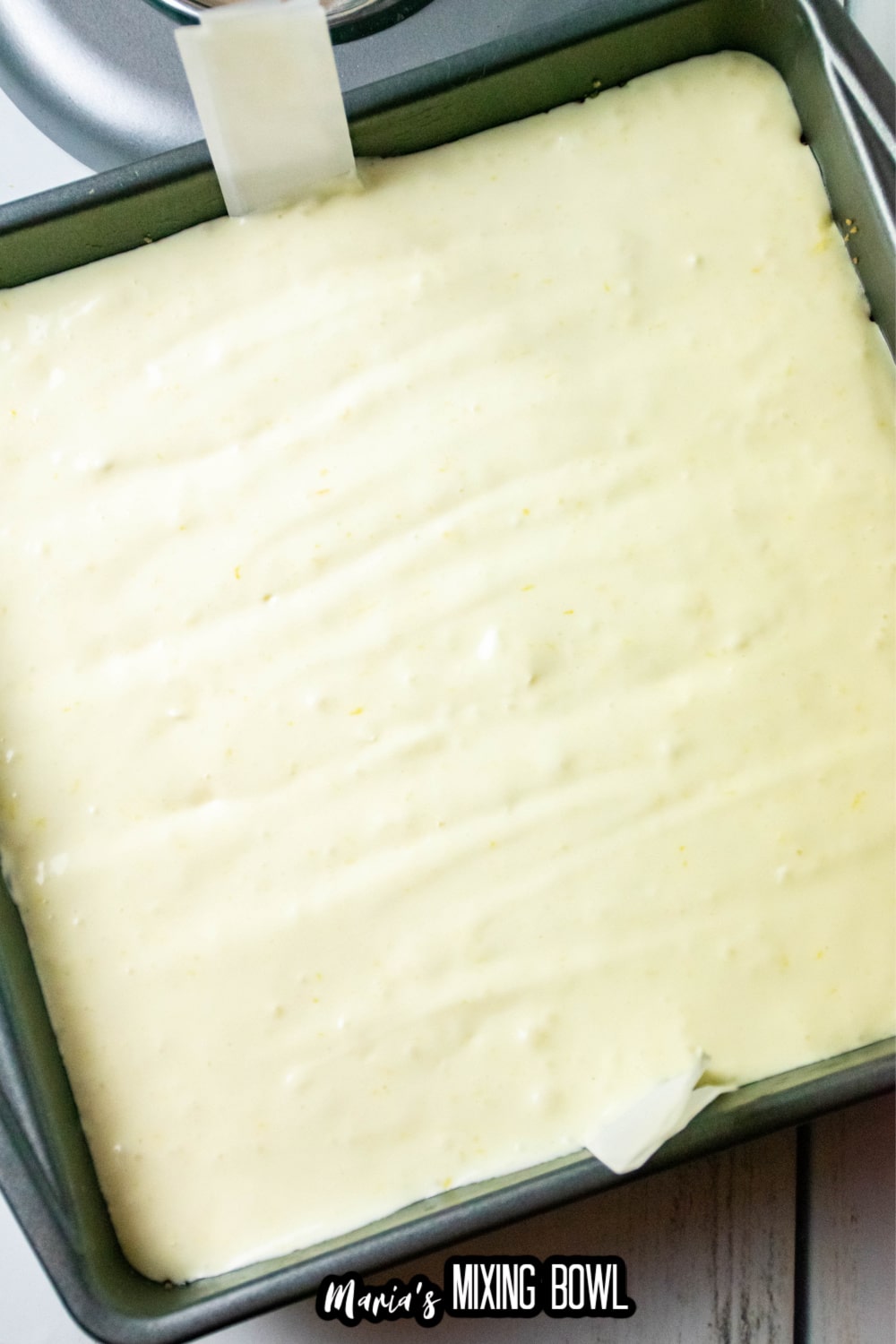 cheesecake batter in a metal baking pan