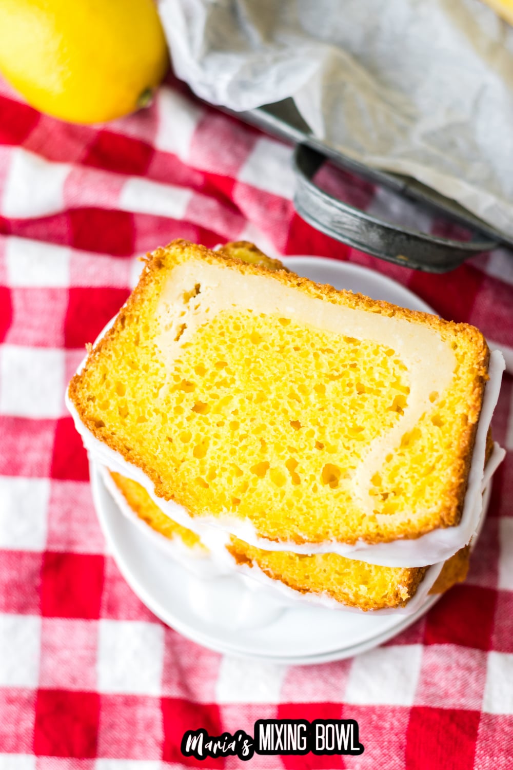three slices of lemon loaf stacked on a small white plate
