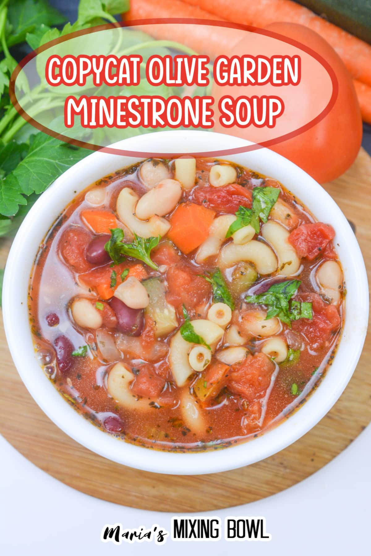 white bowl on a wooden hot pad filled with minestrone soup
