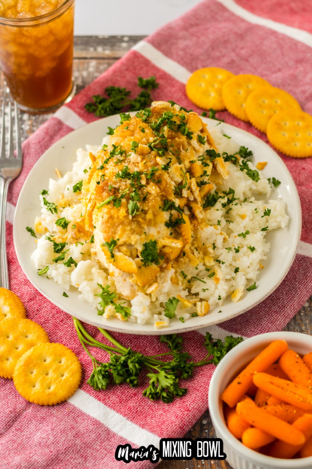 ritz cracker chicken breast on a bed of rice on a white plate