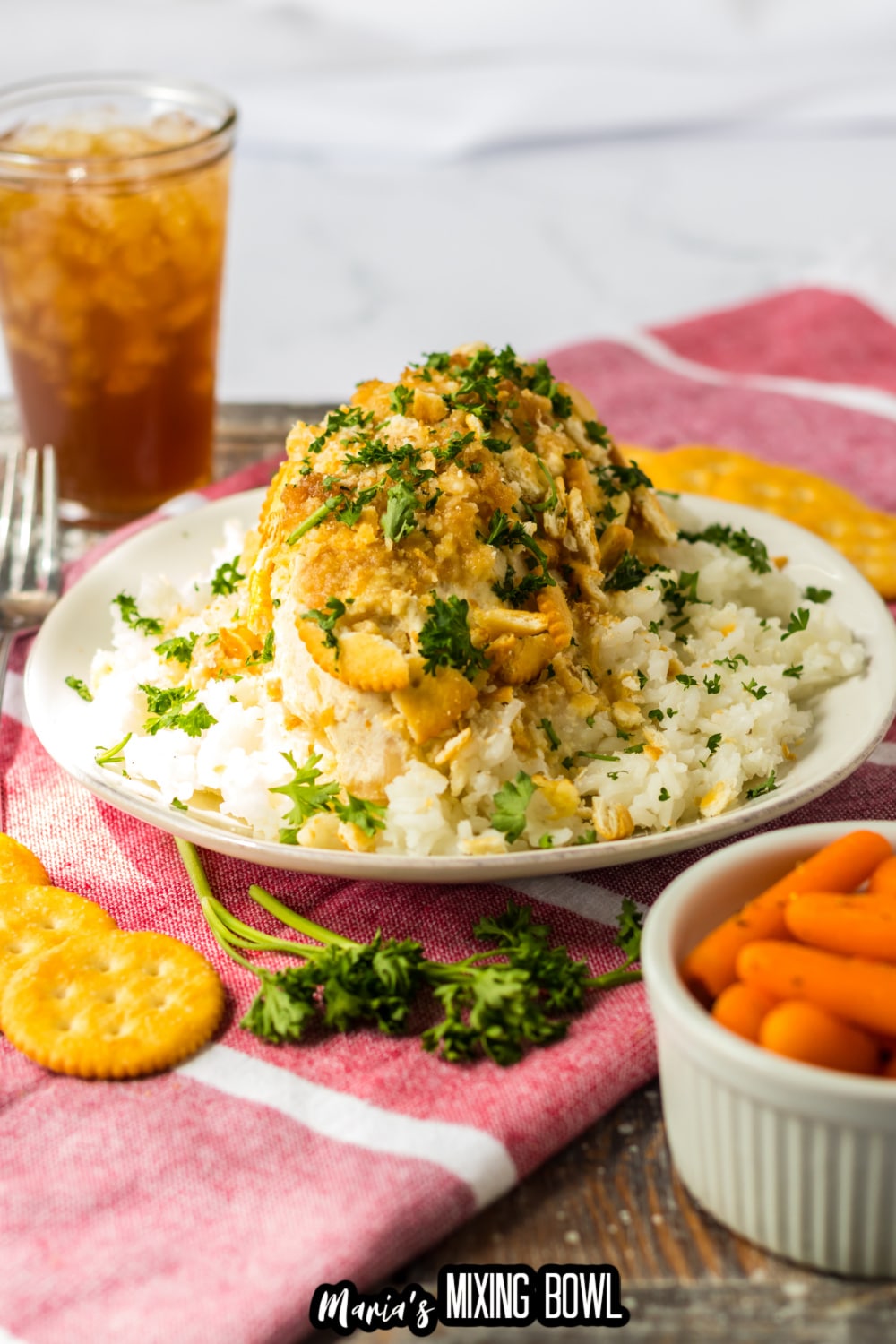 ritz cracker chicken breast on a bed of rice on a white plate