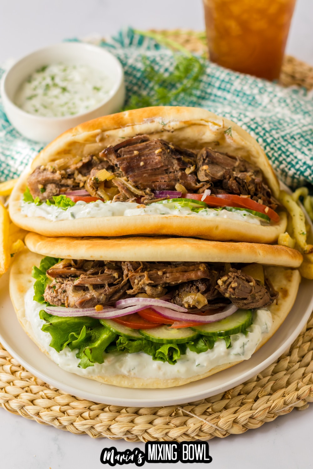 two slow cooker gyros on a white plate