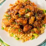 plate of slow cooker orange chicken on a bed of rice
